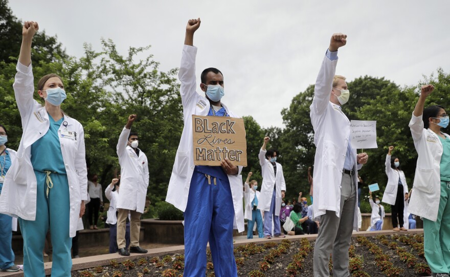 Healthcare professionals gather outside Barnes-Jewish Hospital in St. Louis to demonstrate in support of the Black Lives Matter movement on June 5. The demonstration, called 'White Coats for Black Lives,' was organized to show solidarity with those protesting the death of George Floyd after being restrained by Minneapolis police officers on May 25.