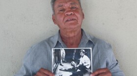 Juan Romero, 67, at his home in Modesto, Calif., holds a photo of himself and Sen. Robert F. Kennedy, taken by The Los Angeles Times' Boris Yaro on June 5, 1968.