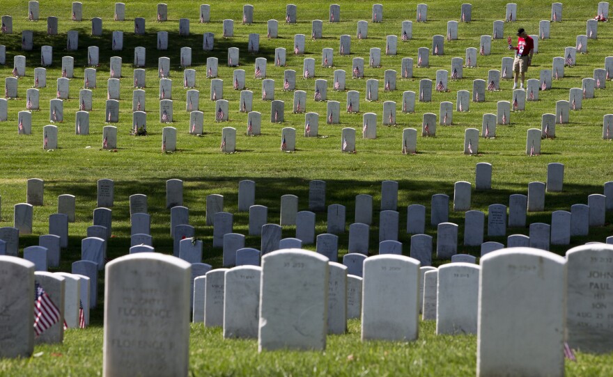 Tom Nicholson of Gretna, Neb., visits graves at Arlington National Ceremony ahead of a Memorial Day ceremonies. His son, Marine Capt. Kevin Nicholson, died serving in Afghanistan in 2014.