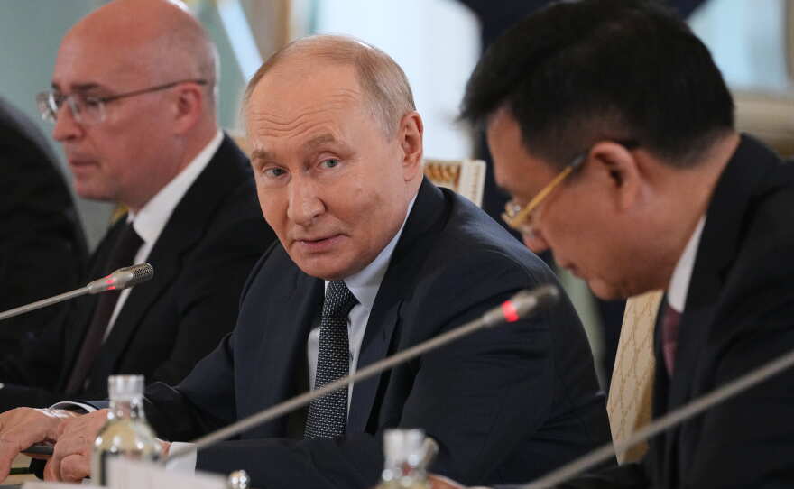 Russian President Vladimir Putin, center, looks at President of Xinhua News Agency Fu Hua, right, while speaking to representatives of international news agencies as General Director of the Russian news agency TASS, Andrey Kondrashov, left, sits near on the sidelines of the St. Petersburg International Economic Forum at the Constantine Palace in St. Petersburg, Russia, on Thursday, June 4, 2026.