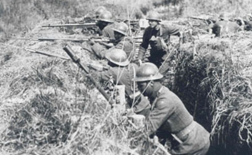 Soldiers of the 369th Infantry during World War I wear French "Adrian" helmets and use French-issued rifles and equipment.