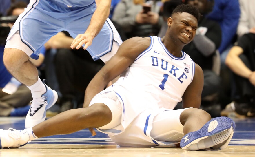 Duke's Zion Williamson reacts after falling as his shoe breaks in the game against the North Carolina Tar Heels Wednesday in Durham, N.C.