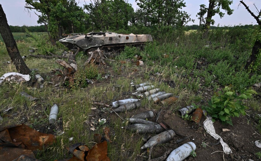Artillery shells sit on the ground ground next to destroyed Russian military vehicles on a field not far of southern city Mykolaiv on Sunday.