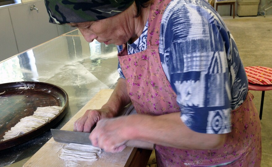 Reiko Tsuzuki, 70, makes buckwheat soba noodles by hand in her restaurant kitchen in the Japanese island of Shikoku.