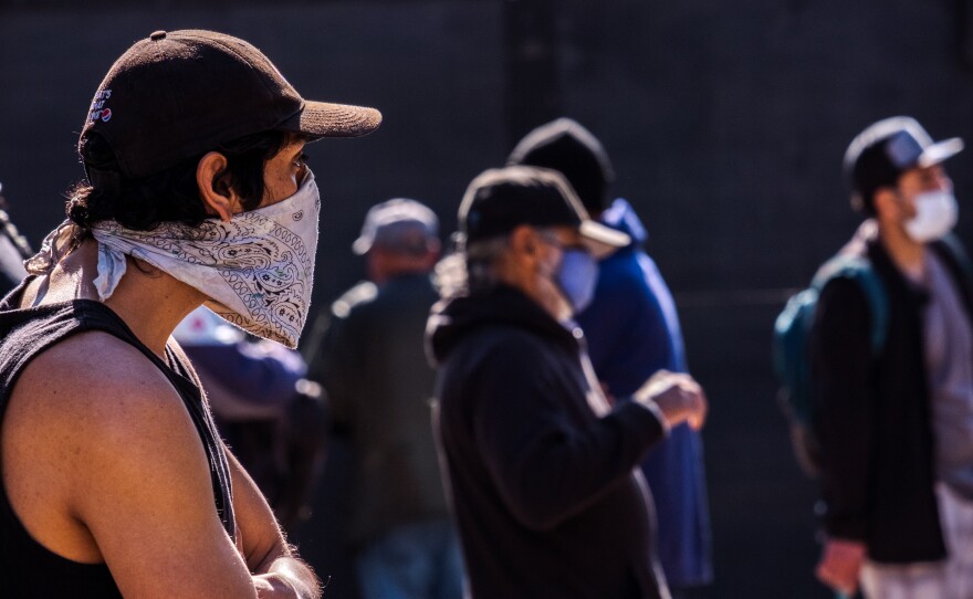 A man waits in line for his to-go Thanksgiving meal at Father Joes in downtown San Diego, November 24, 2021.<br/>