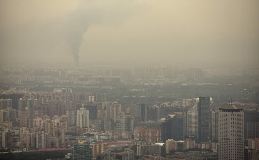 Smoke rises above the skyline of Beijing on a moderately polluted day in 2017.