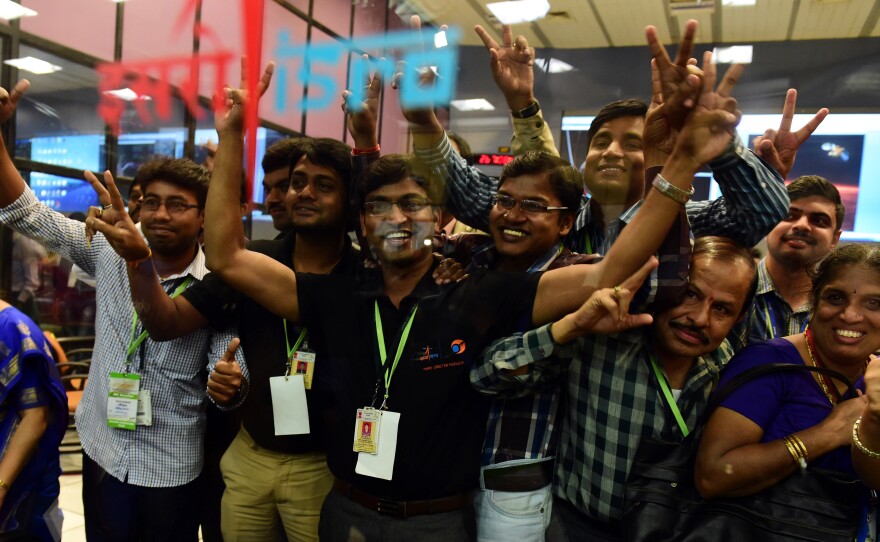 Scientists and officials of Indian Space Research Organization pose for photos as they celebrate the success of Mars Orbiter Mission (MoM)  on Wednesday.