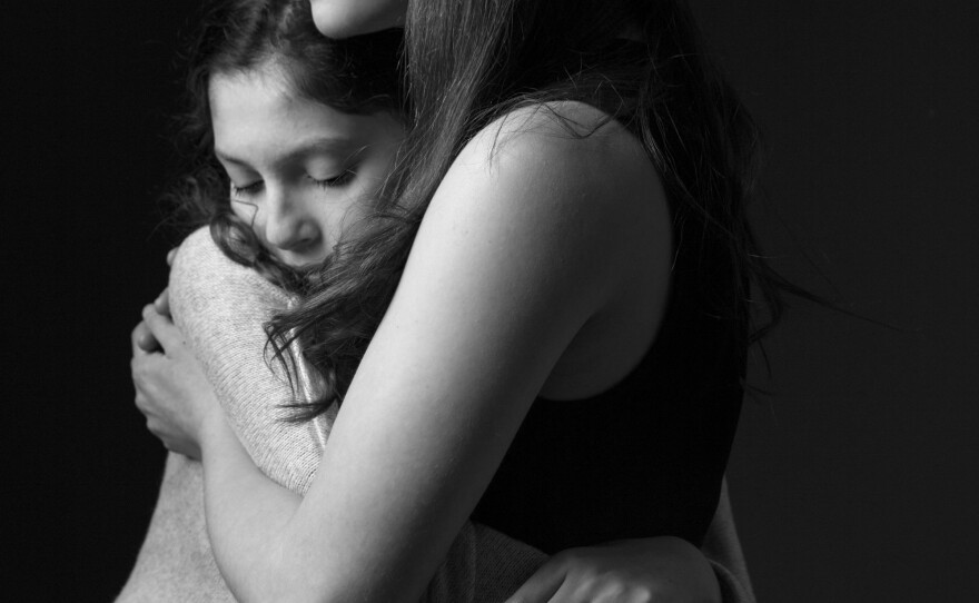 Lola and photographer Moriah Ratner share a quiet moment. The two considered each other close friends. Ratner says sometimes Lola would grow sad, knowing that "the only reason" she met Ratner was because of her sickness.