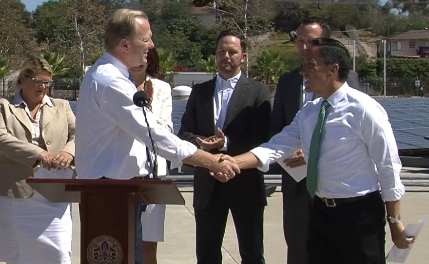 San Diego Mayor Kevin Faulconer shakes the hand of Council President Todd Gloria at a press conference unveiling the mayor's climate action plan, Sept. 30, 2014 