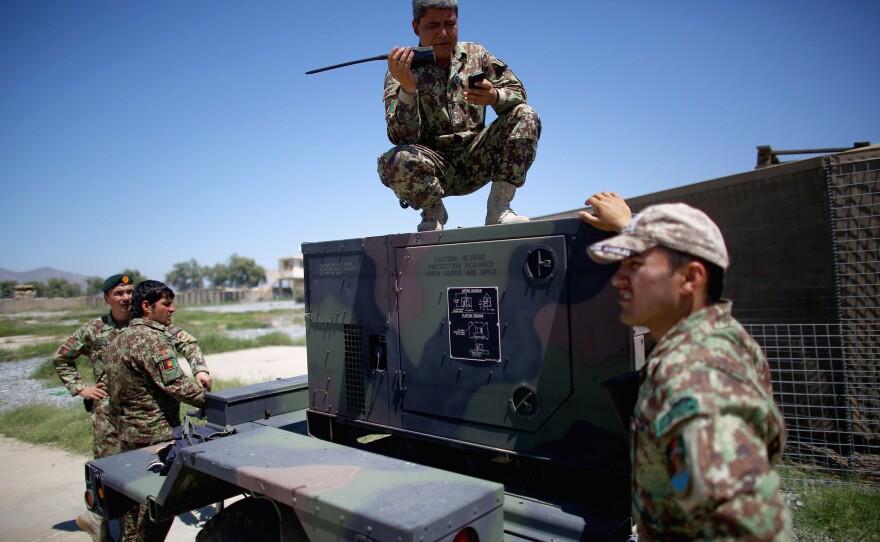 Afghan army battalion commander, Lt. Col. Ghani Khel, talks with his soldiers after successful strike on a Taliban truck and rocket launcher.