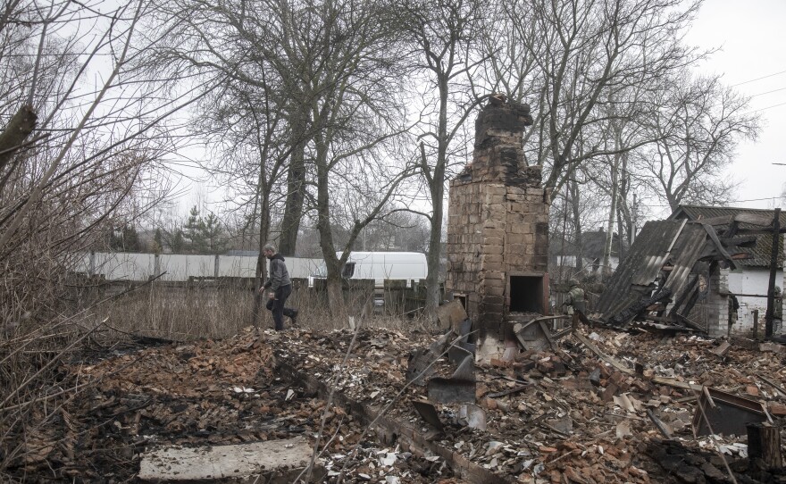 Members of the Ukrainian Territorial Defense Forces walk through Nova Basan after retaking the village from the Russian army on April 1.