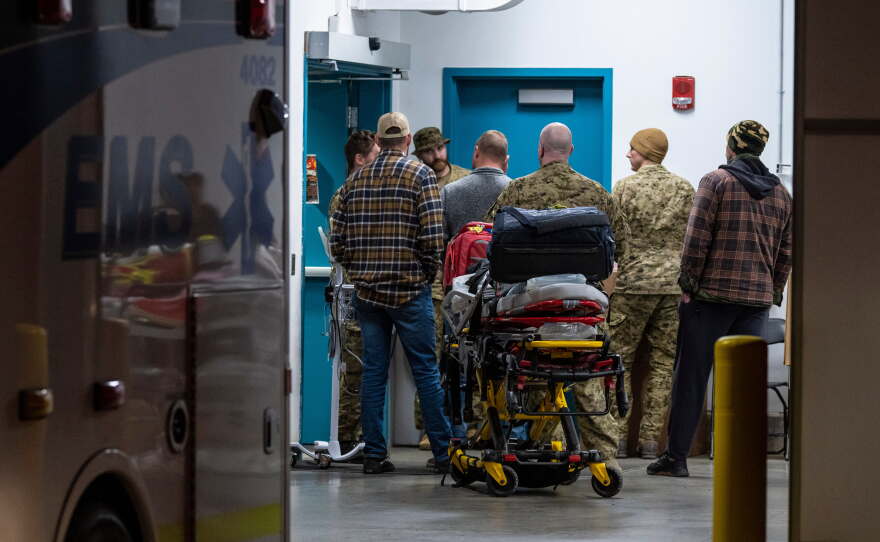 Emergency crews and military personnel are seen at the Wainwright Health Centre as injured military members are treated after a fire at Canadian Forces Base Wainwright, outside of Wainwright, Alberta Saturday, Oct. 17, 2026.