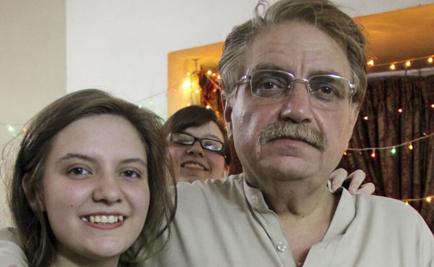 Idris Khattak disappeared in November. He is pictured with daughters Talia Khan and Shumaisa (in the background), on July 29, 2015, in Islamabad.