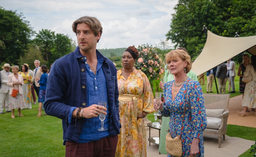 Shown L-R: Tristram Bailey (Tom Stourton), Suzie Harris (Jo Martin), Judith Potts (Samantha Bond) in MASTERPIECE: THE MARLOW MURDER CLUB, Season 2.  