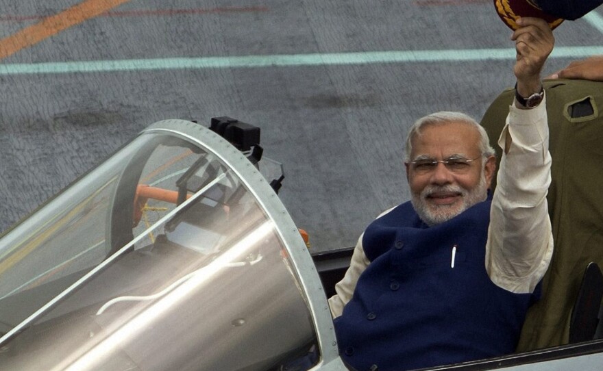 India's Prime Minister Narendra Modi waves from a MIG 29 fighter aboard the country's largest warship, INS Vikramaditya, off the coast of Goa, India, on June 14.