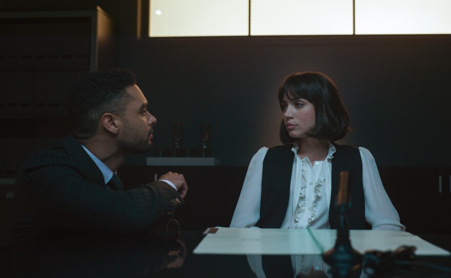 Rege-Jean Page as Carmichael and Ana de Armas as Dani Miranda. Courtesy of Netflix © 2022