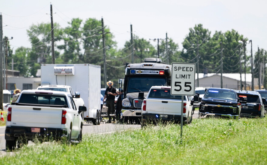 Emergency vehicles are parked outside the Butler Memorial Airport after a plane crash in Butler, Mo., on Sunday.