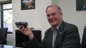 Steve Sampson of Cubic holds the rifle scope that contains new laser-technology to identify whether the target is friend or foe. 