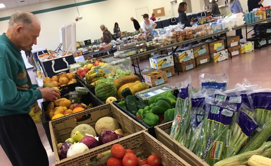 A volunteer with the Saddleback Church prepares produce as part of the group's food pantry at Camp Pendleton. The church typically serves about 100 active duty military families as part of its monthly food pantry.