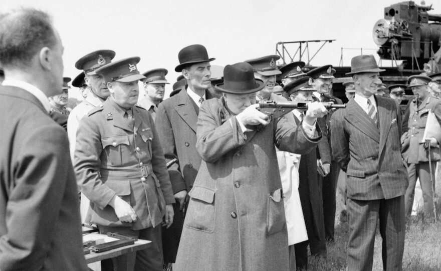 THE 100 DAYS "Blitzkrieg- 1940" - Winston Churchill As Prime Minister 1940-45. Winston Churchill takes aim with a Sten gun during a visit to the Royal Artillery experimental station at Shoeburyness in Essex, 13 June 1941.