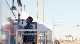 A person gets tested for COVID-19 at a mobile testing facility parked outside of the El Centro Public Library, Dec. 18, 2020.