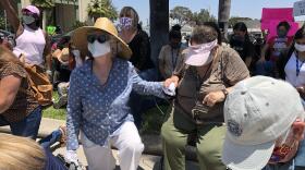 Escondido residents take a knee to protest the death of George Floyd at the hands of police, June 3, 2020. 