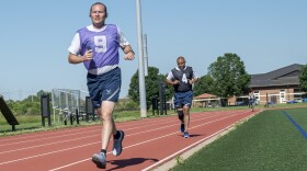 Air Force troops run a timed 1.5 miles during their annual physical fitness test at Scott Air Force Base in Illinois on June 9, 2022. The U.S. Space Force intends to do away with a once-a-year assessments in favor of wearable technology that constantly tracks fitness.