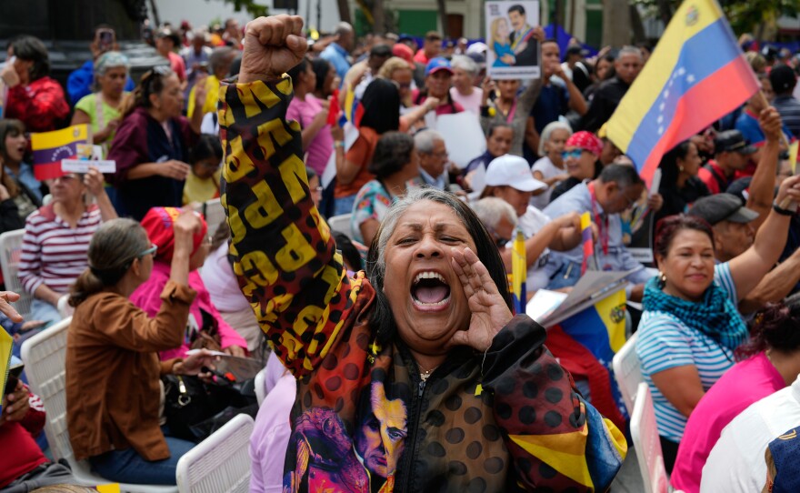 A woman screams during a government-organized event to watch former President Nicolas Maduro and first lady Cilia Flores appear in a New York court on a screen in Caracas, Venezuela, Thursday, March 26, 2026.