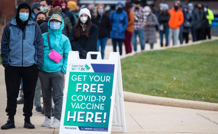People wait in line at a walk-up vaccination site in Washington, D.C., in November 2021.