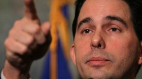 Wisconsin Gov. Scott Walker speaks to the media outside his office at the Capitol last week in Madison. Protesters have occupied the building for two weeks while the governor has tried to push through a bill that would restrict collective bargaining for most government workers.