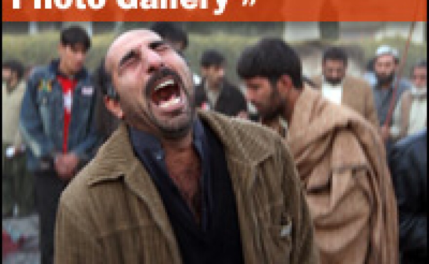 A man cries, following an attack on Bhutto's life at an election rally Rawalpindi. Immediately after Bhutto was declared dead, angry supporters went on a rampage, attacking police and burning tires and election campaign posters in several cities.