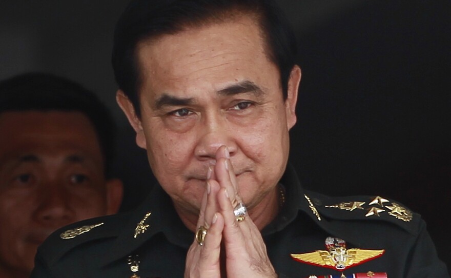 Thailand's newly appointed Prime Minister Prayuth Chan-ocha gestures in a traditional greeting during his to a unit of the Queen's Guard outside of Bangkok on Thursday.