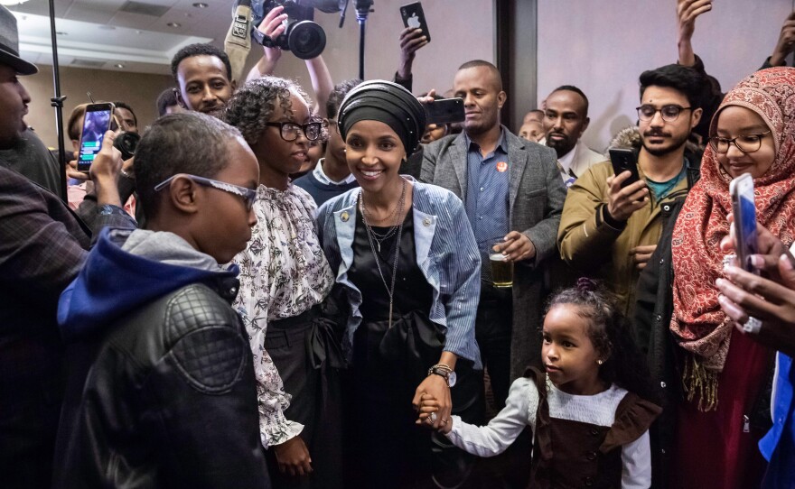 Democrat Ilhan Omar (center), newly elected to the House of Representatives, arrives for her victory party in Minneapolis on Tuesday. Voters elected two Muslim women, both Democrats, to Congress, marking a historic first.