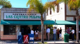 A line of people wait to order at the former location of Las Cuatro Milpas in this undated image.