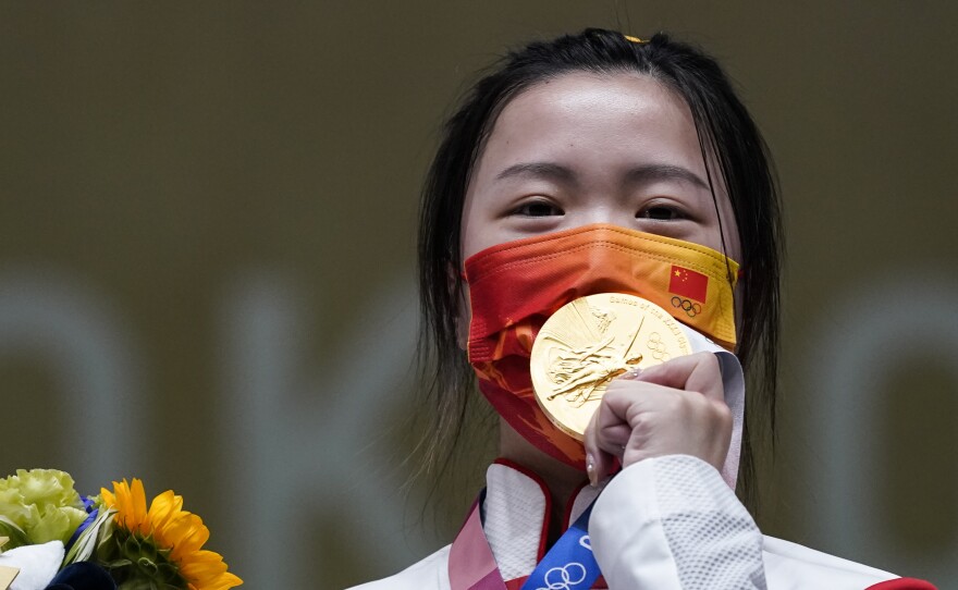 Qian Yang of China celebrates after winning the gold medal in the women's 10-meter air rifle at the Asaka Shooting Range in the 2020 Summer Olympics on Saturday.