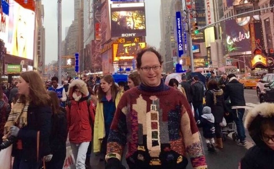 Barsky stands in New York City's Times Square wearing none other than his sweater of Times Square.