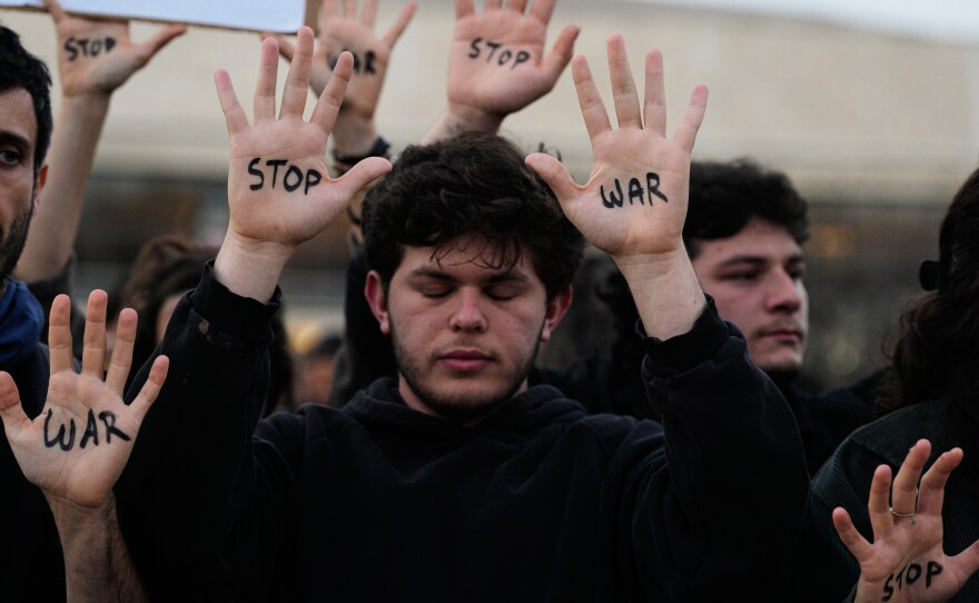 People raise their hands during a protest calling for an end to the war in Tel Aviv, Israel, Saturday, April 4, 2026.