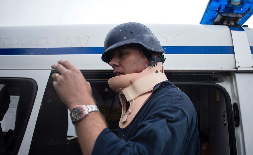 Australian journalist Adam Harvey wears a neck brace Thursday after being struck by a stray bullet in the Philippine city of Marawi.