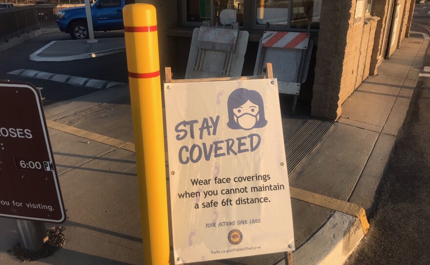 A sign advising visitors to wear a face covering at Torrey Pines State Natural Reserve. Oct. 29, 2020. 