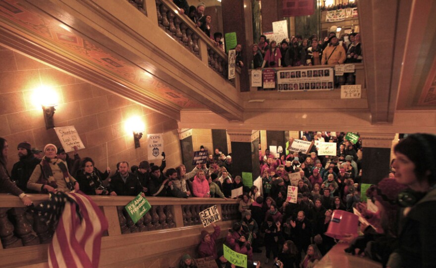 Protesters demonstrate outside the office of Wisconsin Gov. Scott Walker during his fireside chat Tuesday at the Capitol.