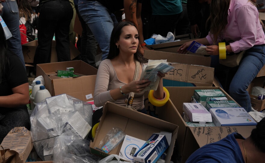 Outside a community center in Bogota, volunteers load boxes with clothes and food onto a truck that will take supplies to victims of Venezuela's earthquake.