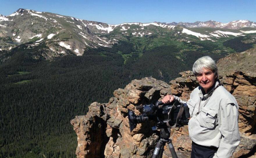 A visitor to Rocky Mountain National Park with camera.