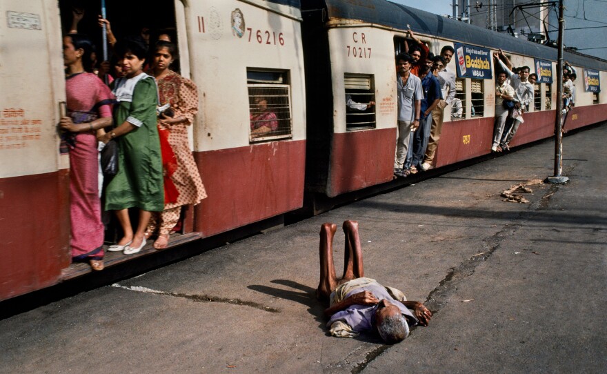 A man lies on a train platform. Mumbai, 1994