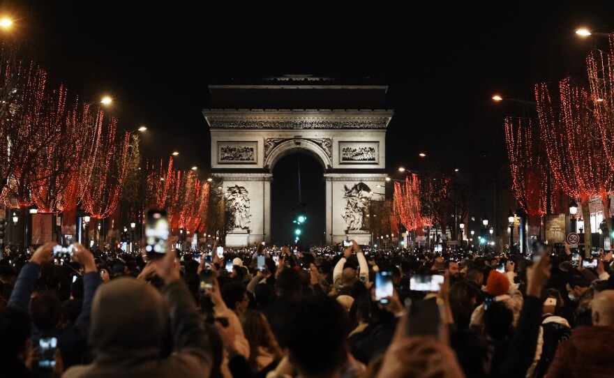 People celebrate the New Year's Eve on the Champs Elysees avenue in Paris on Friday.