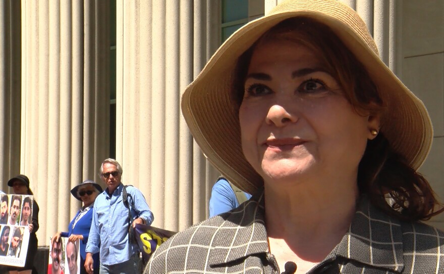Iranian-American Mona Memarian is shown at a protest outside the Hall of Justice on April 7, 2026.