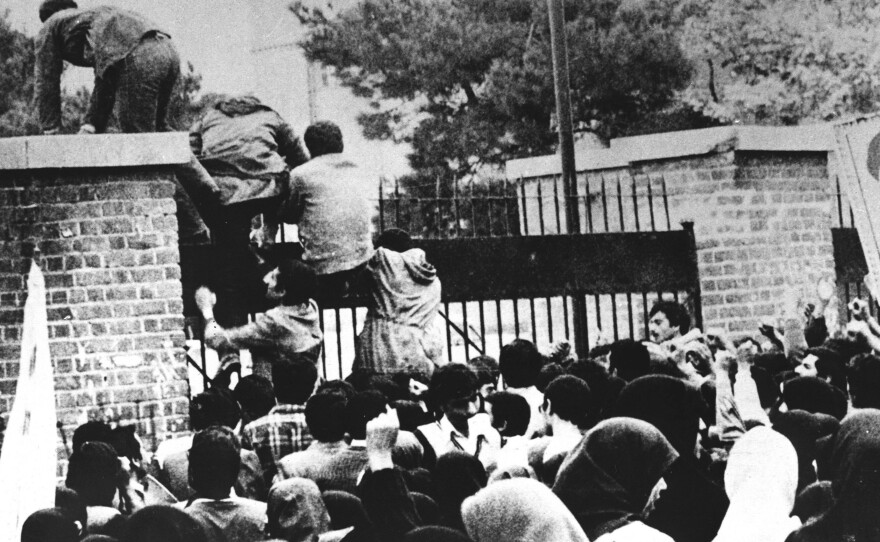 Iranian students climb over the wall of the U.S. embassy in Tehran on Nov. 4, 1979.