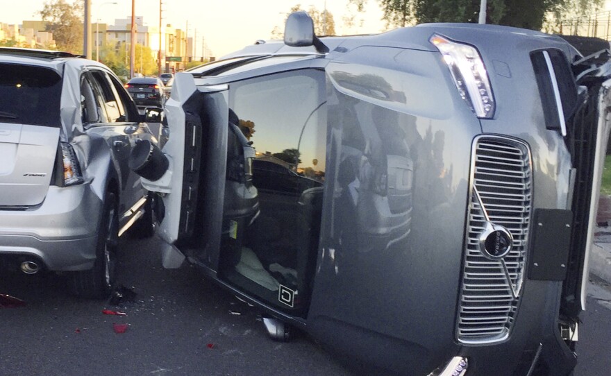 This March 24 photo provided by the Tempe, Ariz., Police Department shows an Uber self-driving SUV that flipped onto its side in a collision.