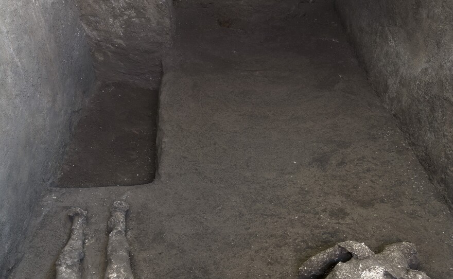 The casts of what are believed to have been a rich man and his male slave fleeing the volcanic eruption of Vesuvius nearly 2,000 years ago, are seen in what was an elegant villa on the outskirts of the ancient Roman city of Pompeii destroyed by the eruption in 79 A.D., where they were discovered during recent excavations, Pompeii archaeological park officials said Saturday, Nov. 21, 2020.