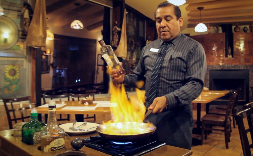 Miguel from El Potrero Restaurant gives us a show as he prepares a flaming banana dessert.