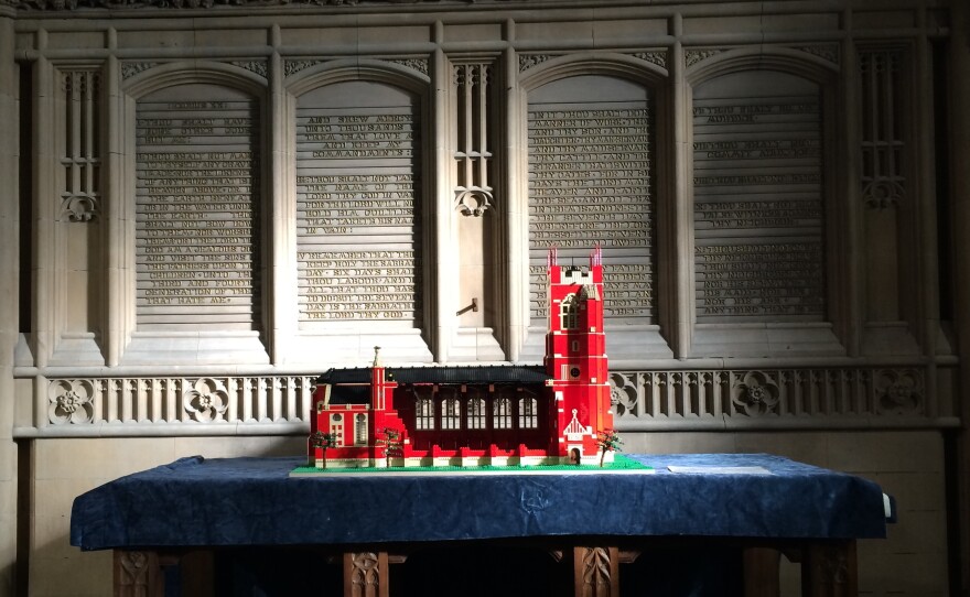 A Lego model of All Souls Church rests on the altar, which was retained when the Bolton, England, church was renovated into an interfaith community center. The model was built by children taking part in an after-school program there.